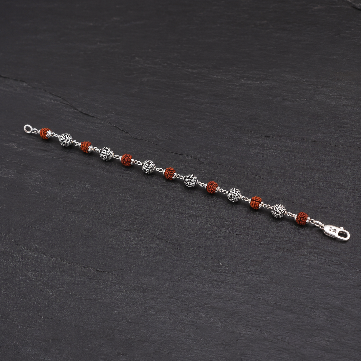 Close-up of 6–7 mm 5 Mukhi Rudraksha and silver mantra beads