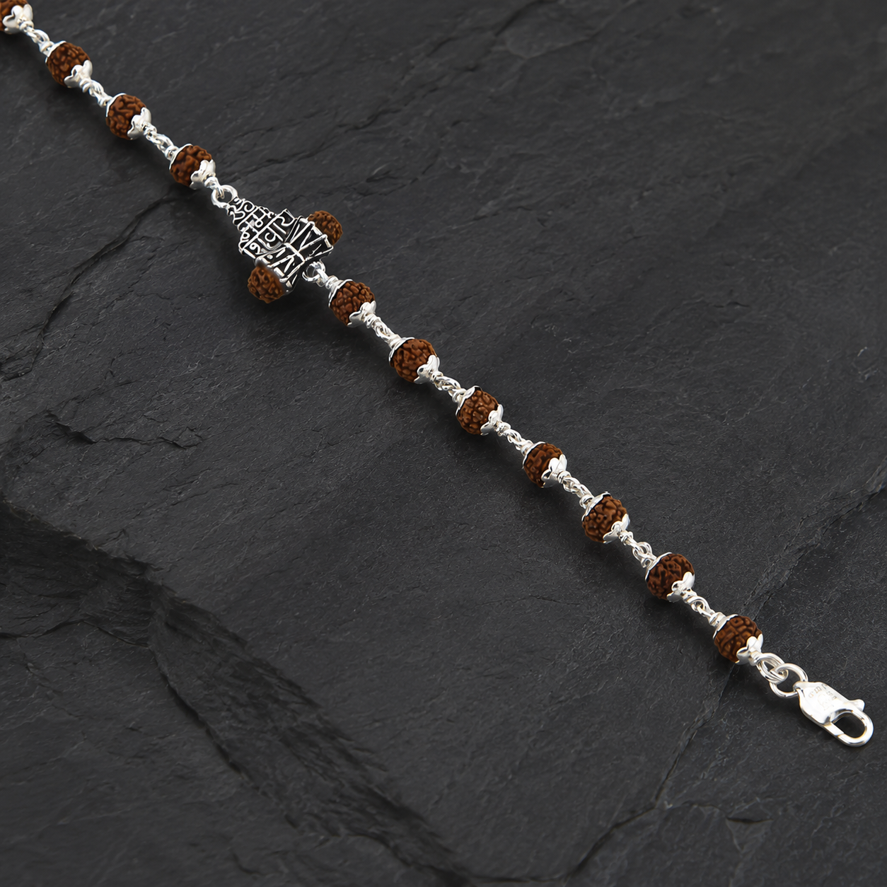 Close-up of 925 silver Om Namah Shivaya centerpiece on Rudraksha bracelet
