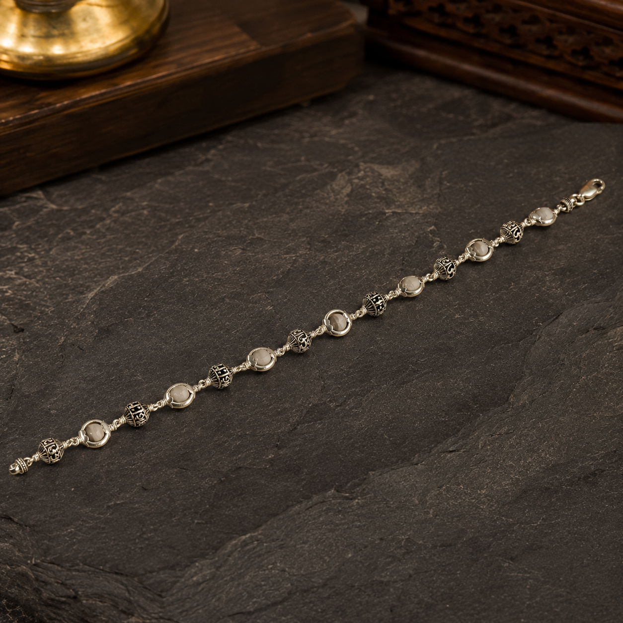Close-up of 925 silver Shiva mantra and Tulsi beads