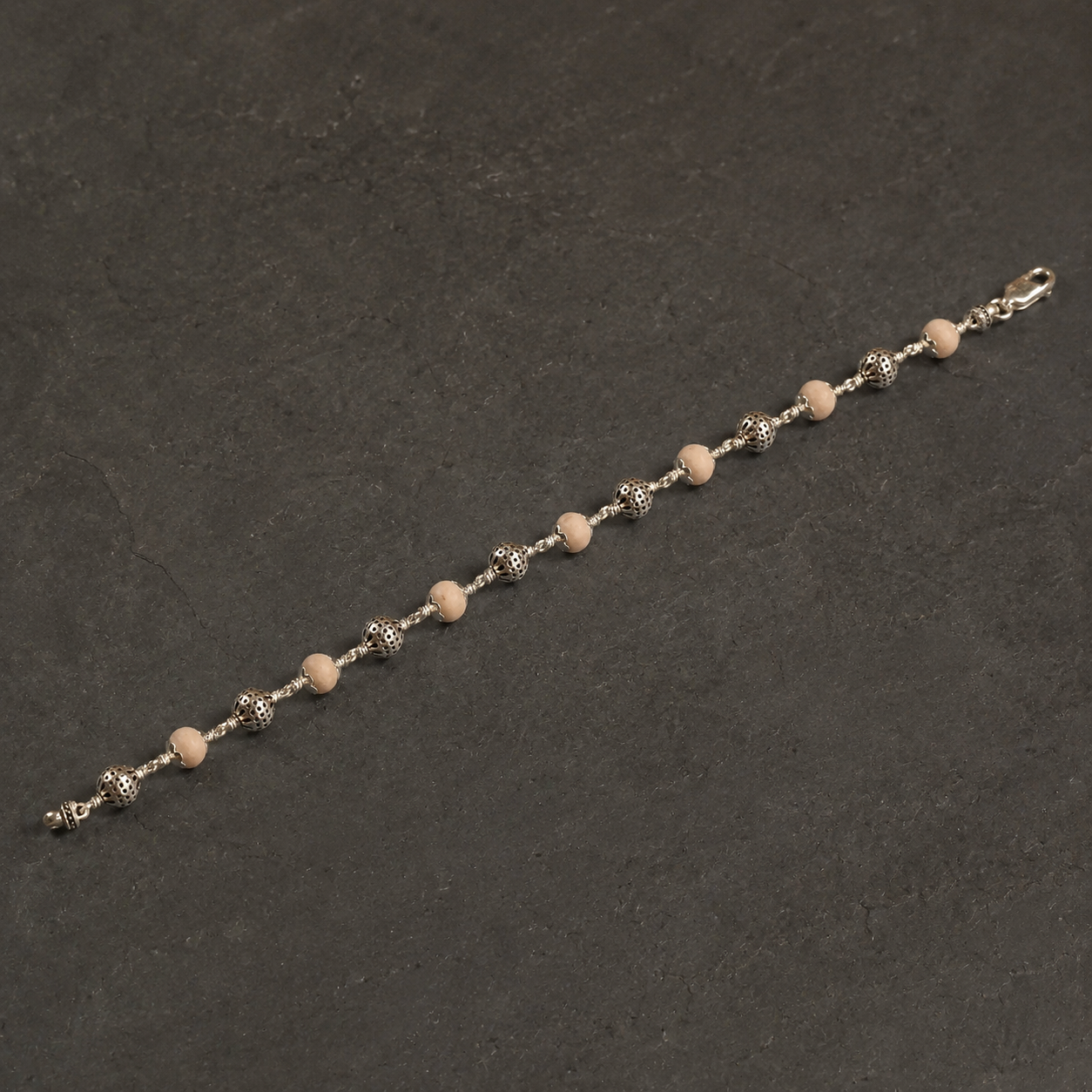 Close-up of 925 silver round beads and Tulsi texture
