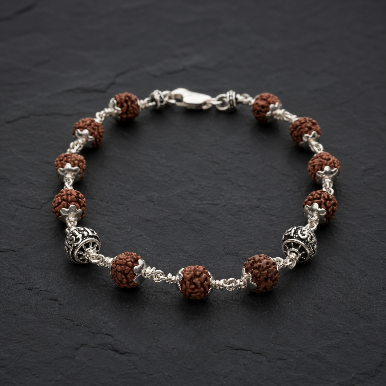 Close-up of Om Namah Shivay silver beads with Rudraksha