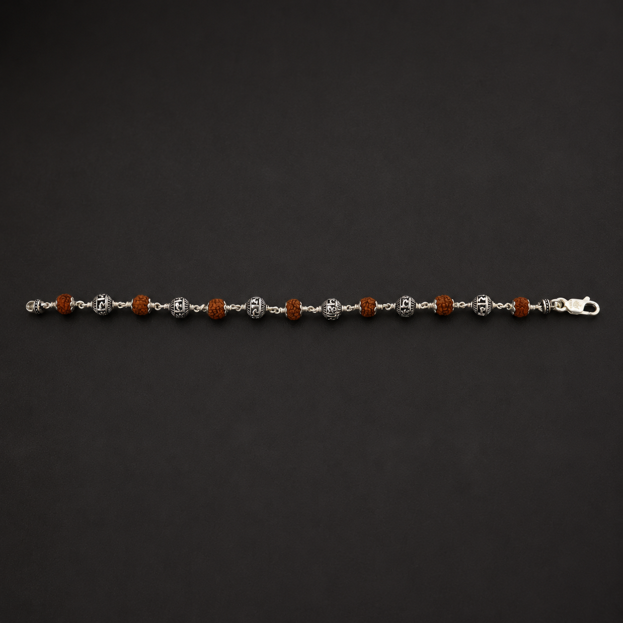 Close-up of engraved Jay Shree Ram sterling silver beads