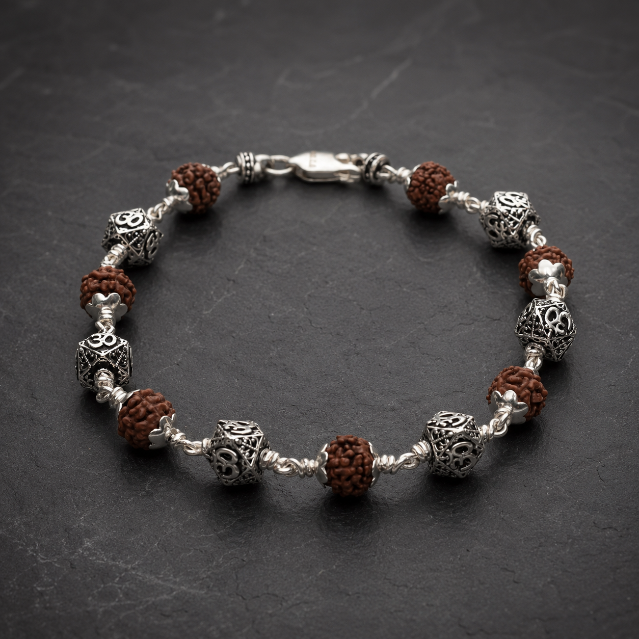 Close-up of hexagonal Om sterling silver bracelet beads