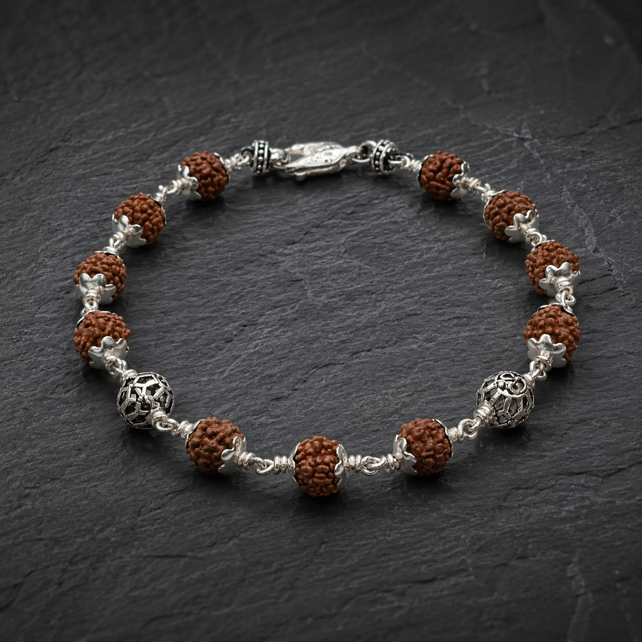 Close-up of intricately designed Round Om sterling silver beads