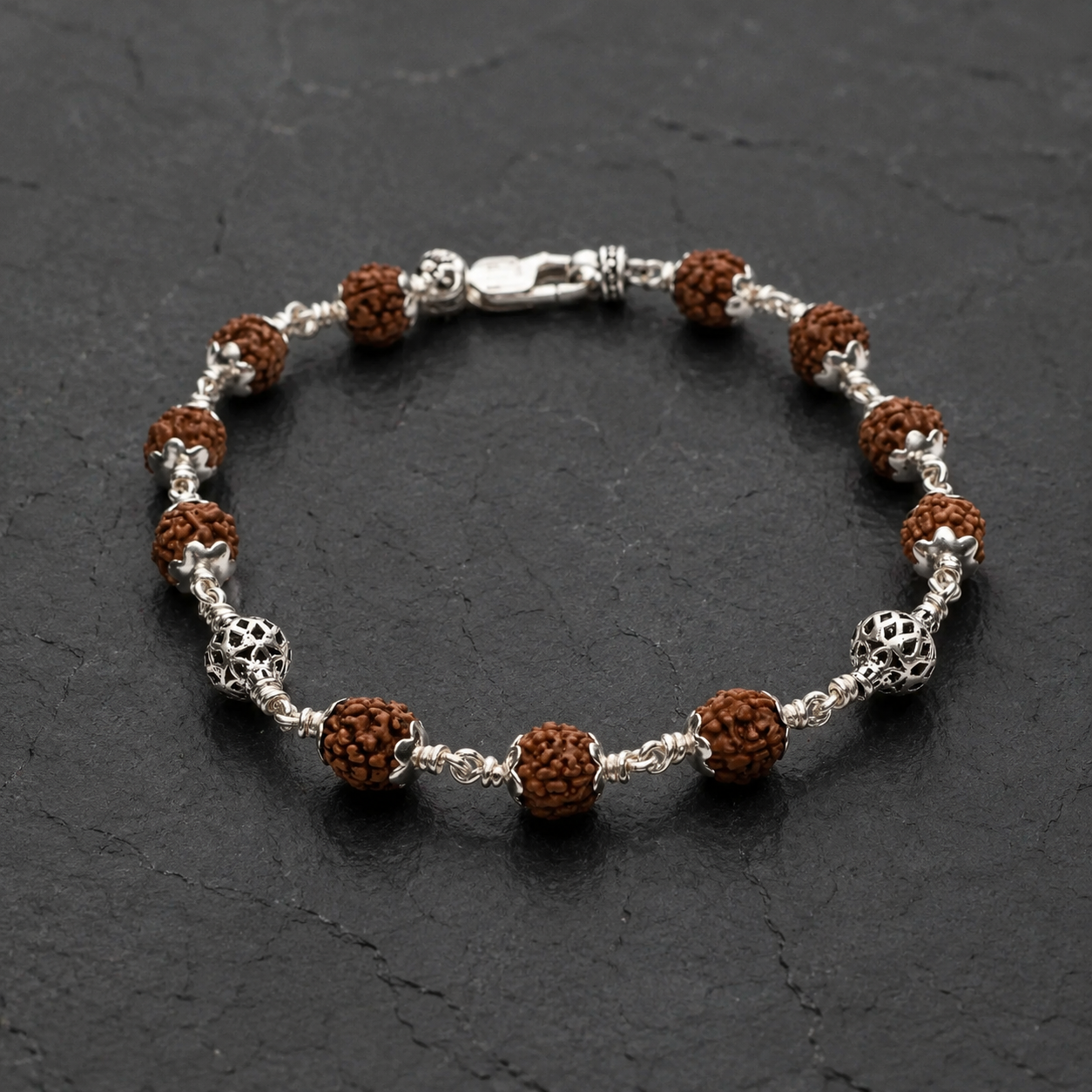 Close-up of intricately designed hollow sterling silver beads