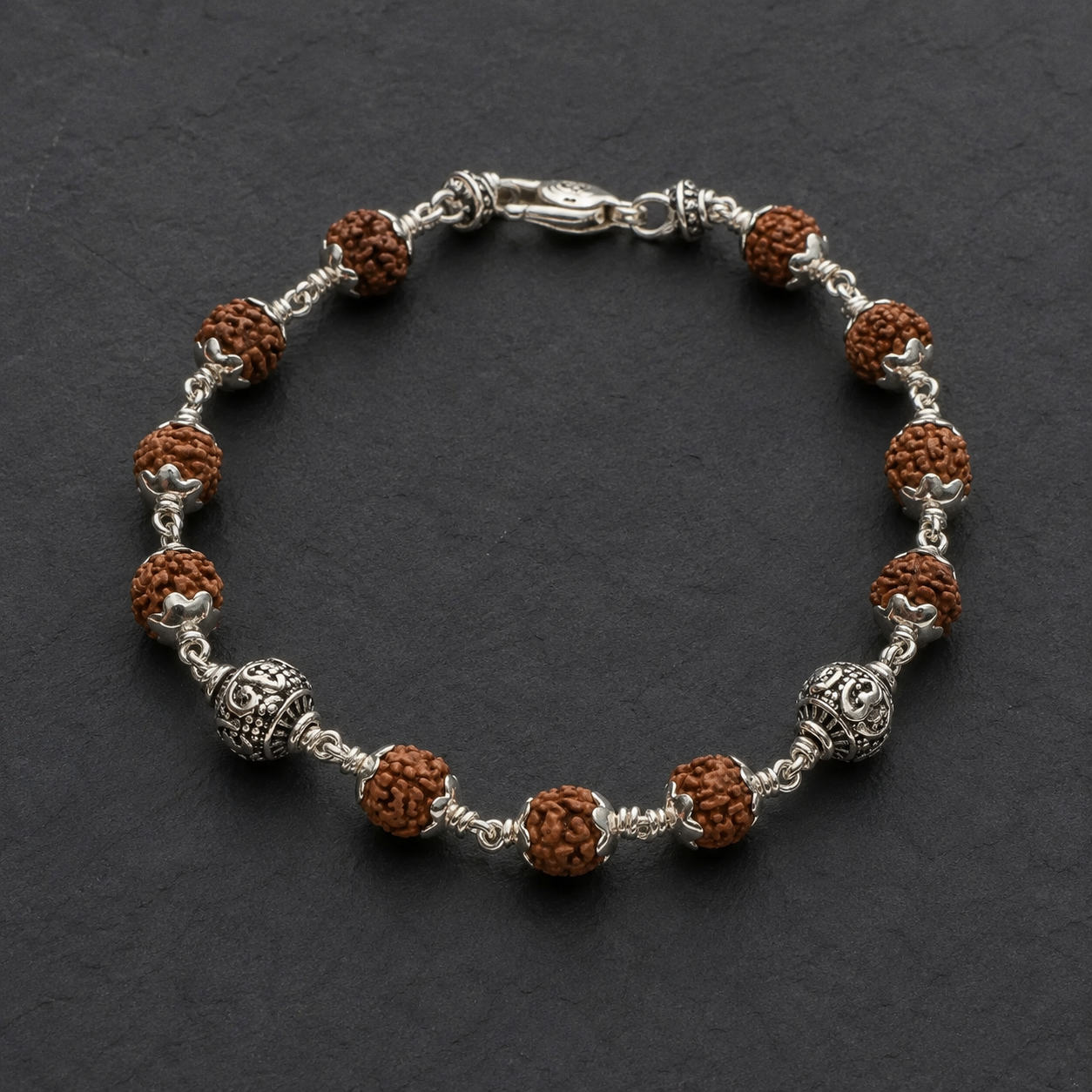 Close-up of polished Om sterling silver bracelet beads