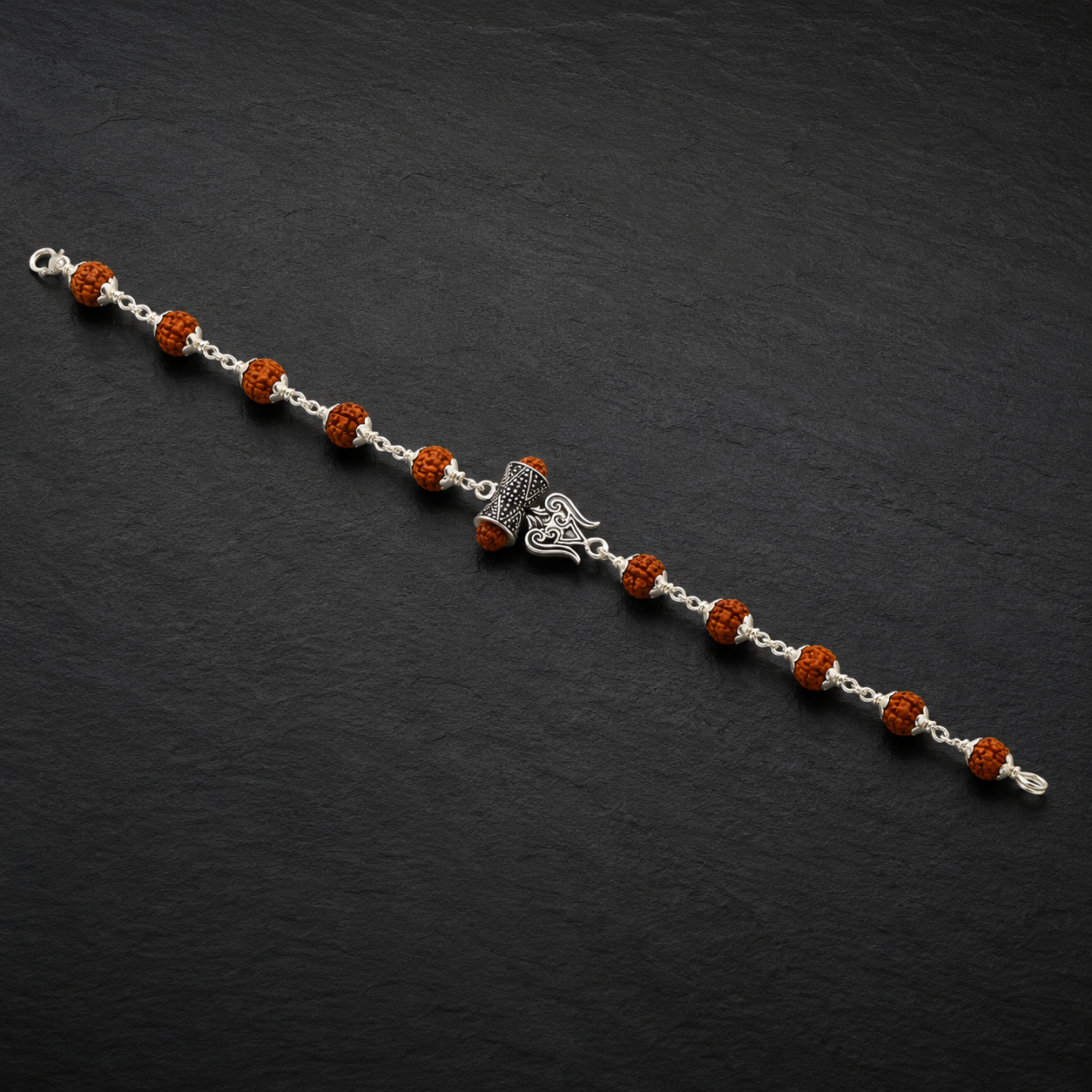 Close-up of sterling silver Trishul and Damru bracelet design