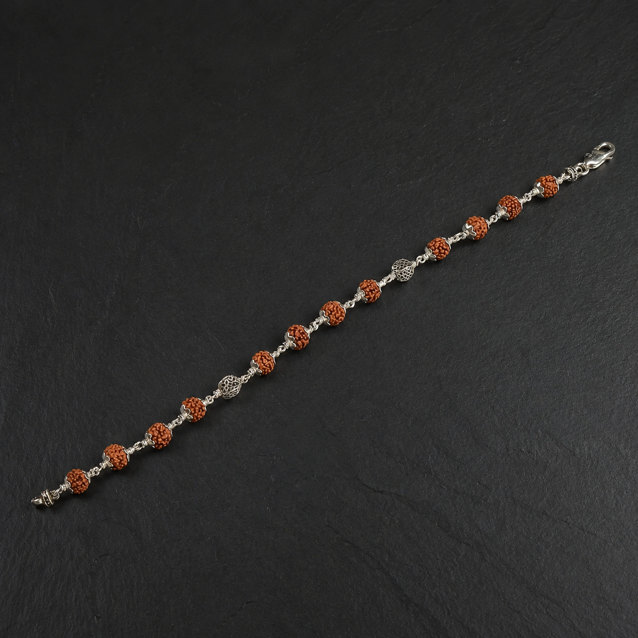 Full view of alternating Rudraksha and circular silver bead bracelet