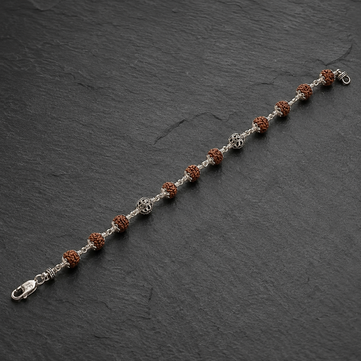 Full view of alternating Rudraksha and silver Om bead bracelet