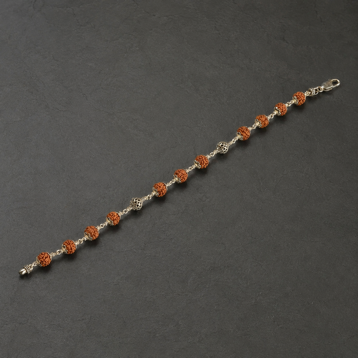 Full view of alternating Rudraksha and silver mesh bead bracelet