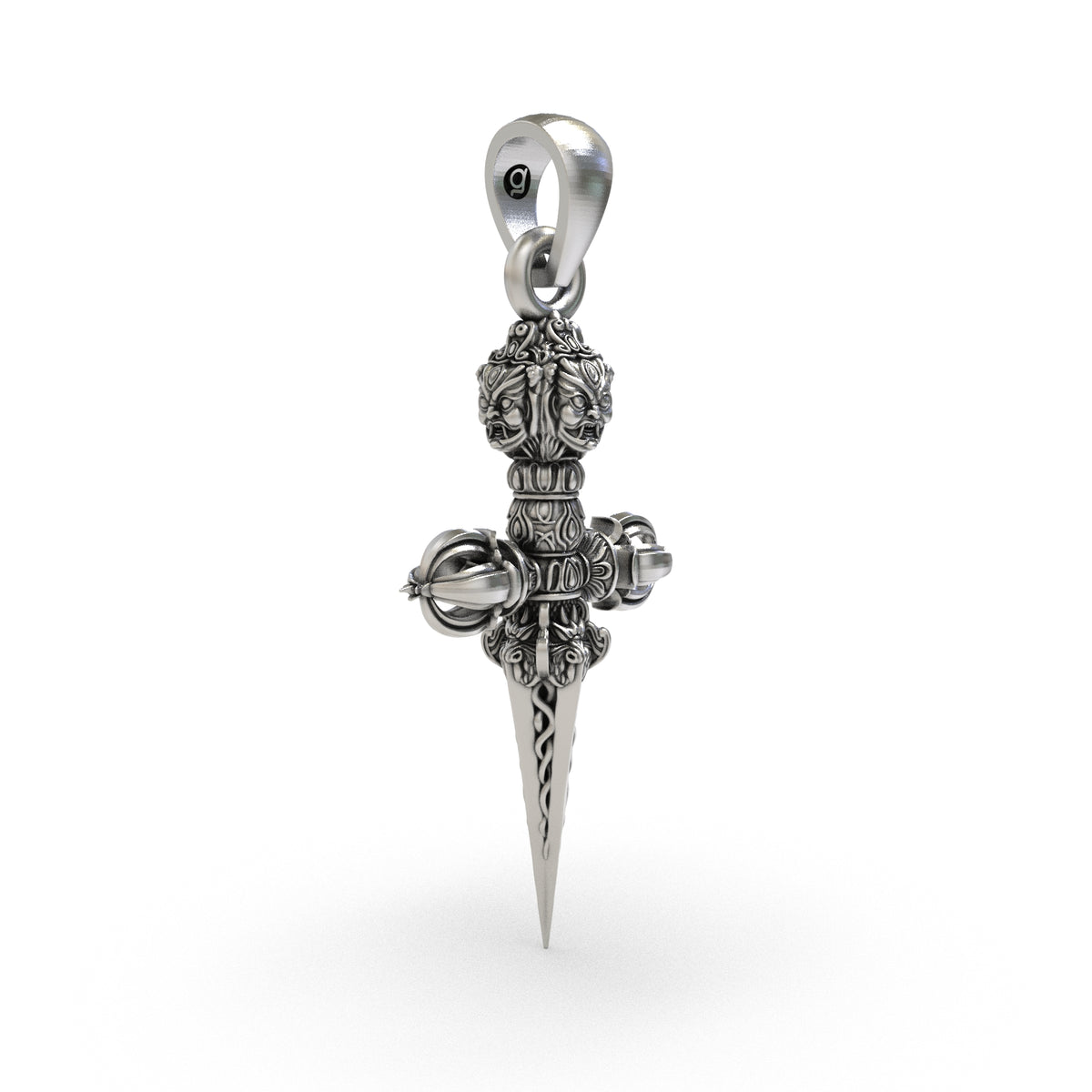 Close-up of fierce sculpted face ornament at the top of Phurba silver pendant