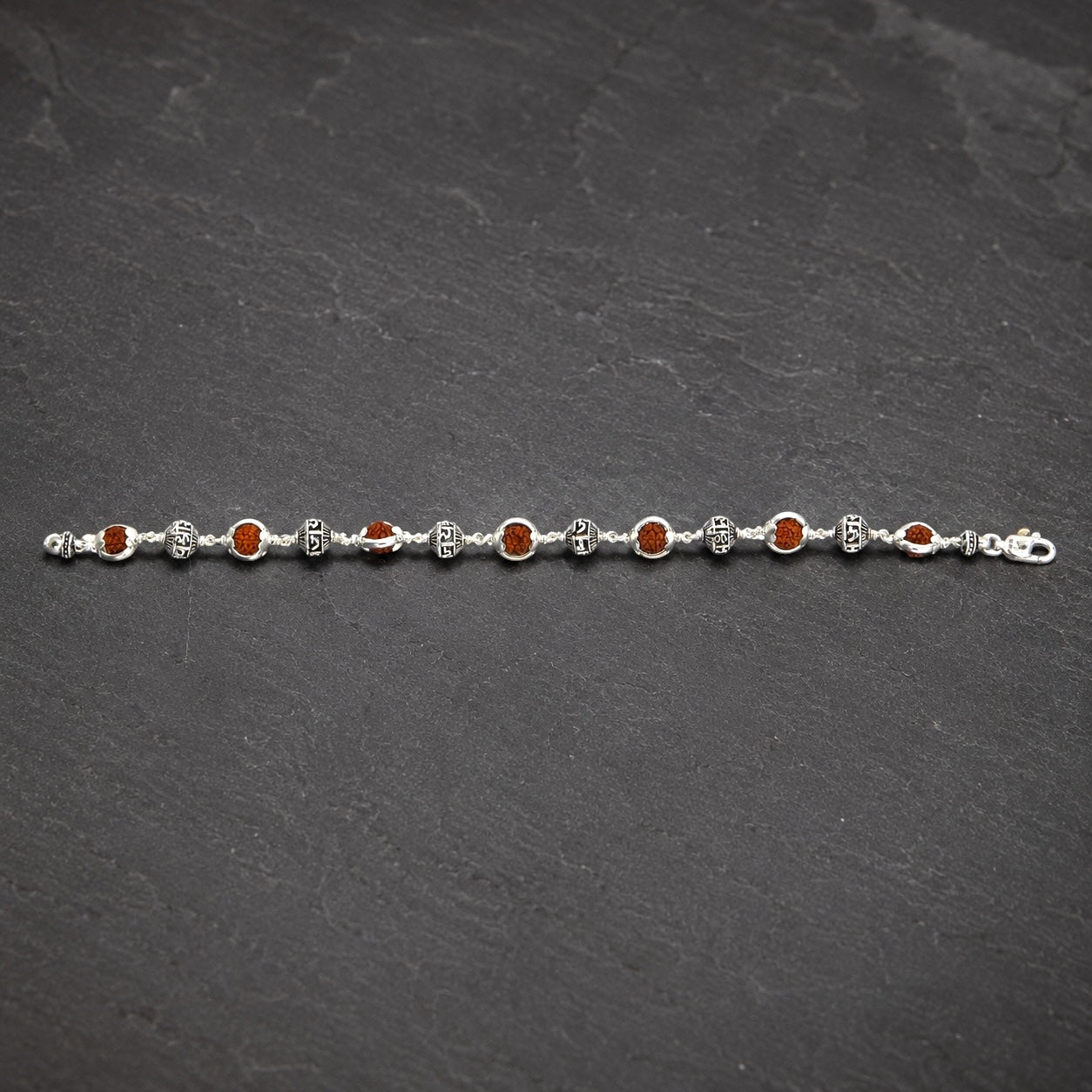 Close-up of Jay Shree Ram sterling silver beads with Rudraksha