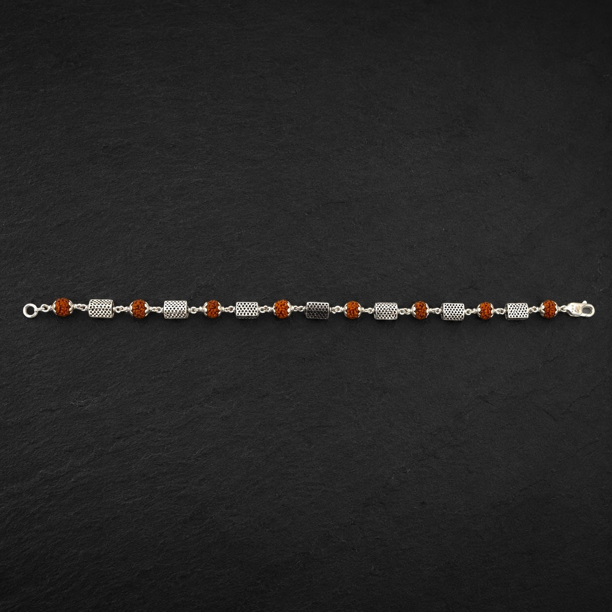 Close-up of geometric sterling silver triangle bracelet beads