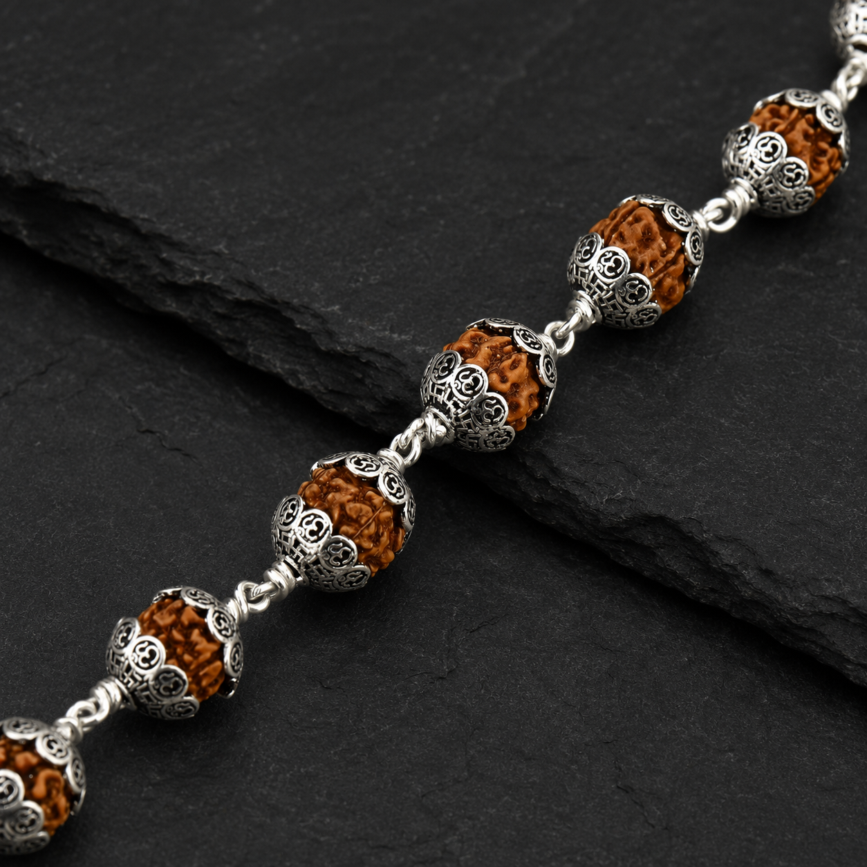 Large Rudraksha bracelet with Om-design 925 silver caps,
