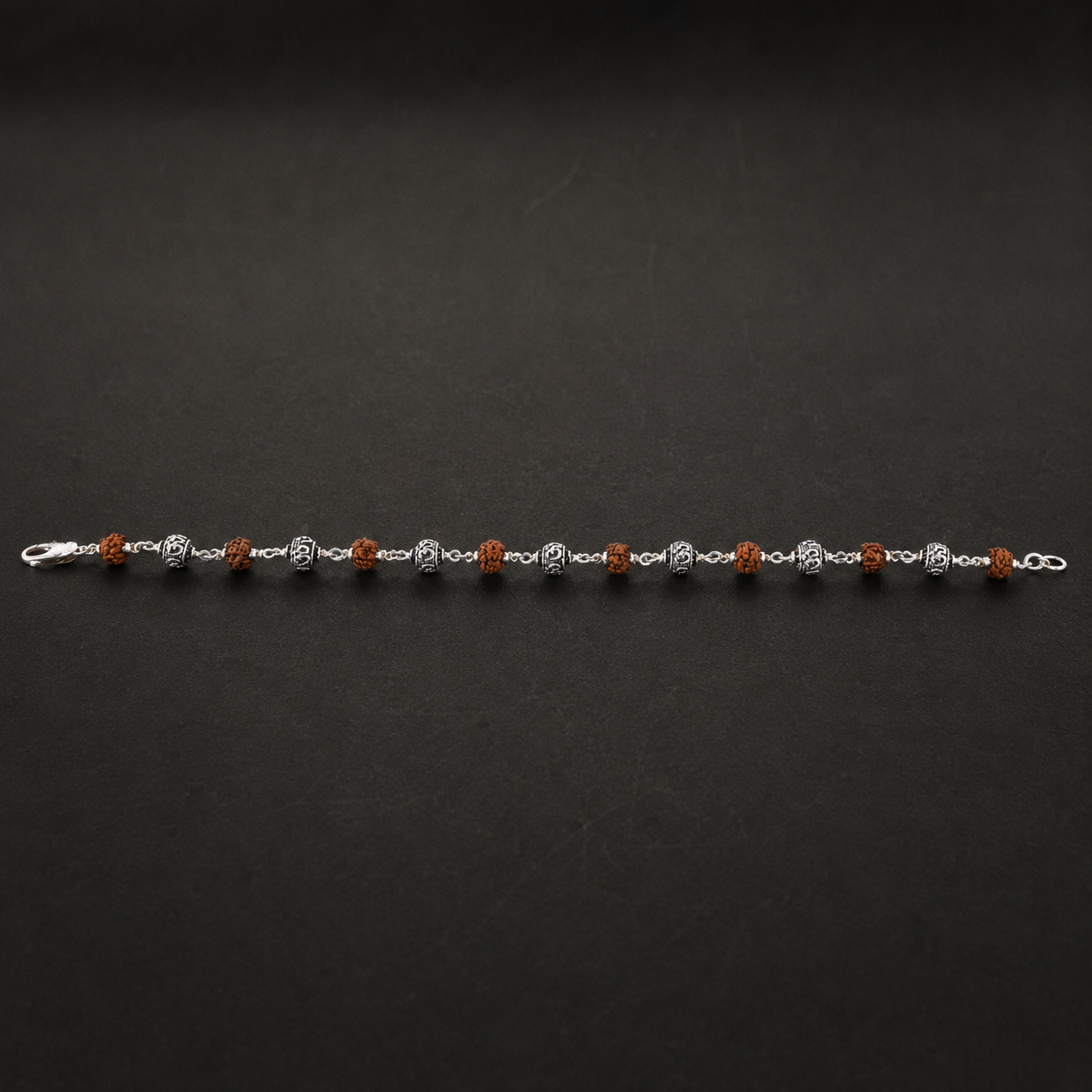 Natural 6–7 mm Rudraksha beads with polished silver detailing