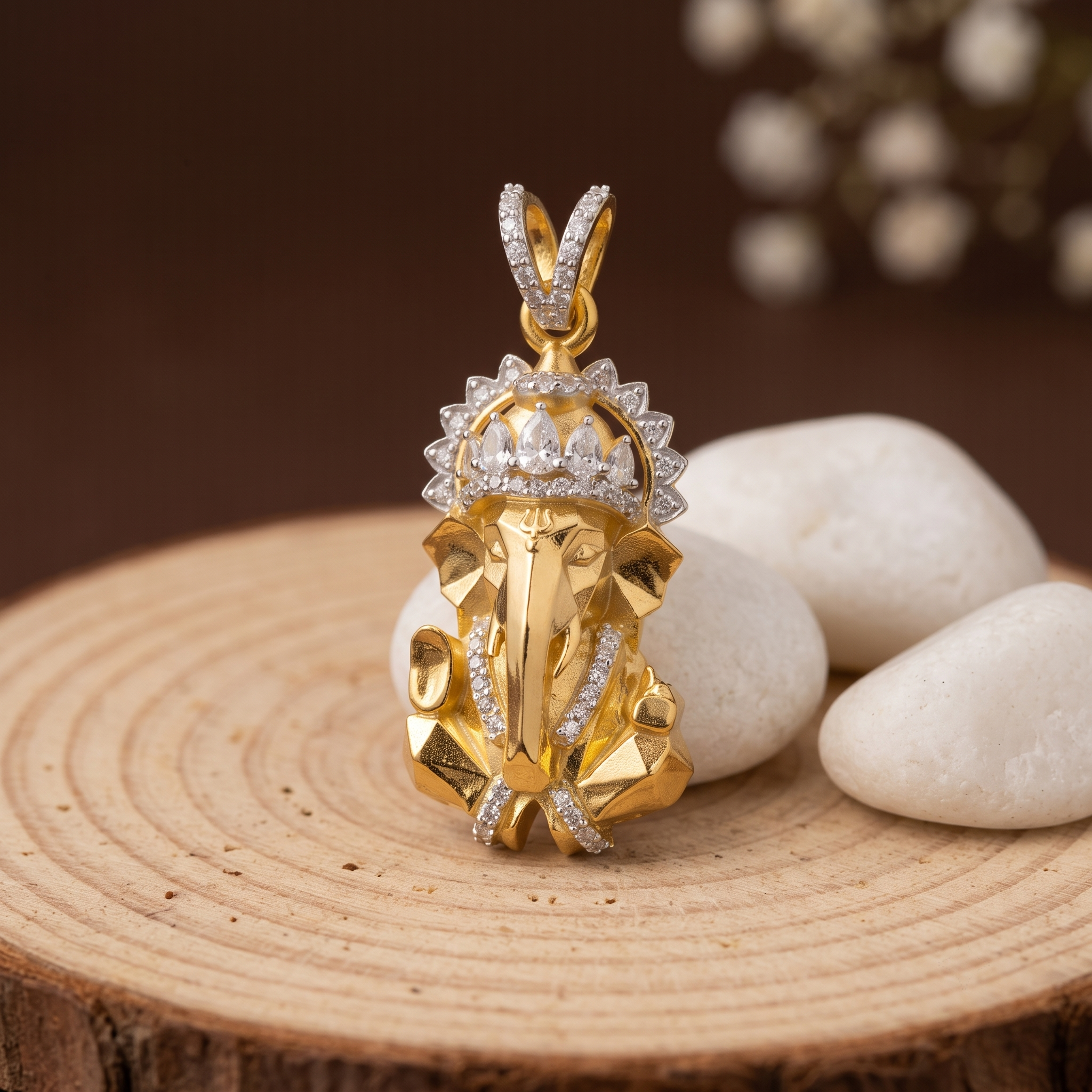 Radiant Ganesh silver pendant shown in hand for scale